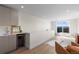 Bright living room featuring a wet bar, modern finishes and a sliding door to access a cozy outdoor balcony at 2466 S Cherokee St, Denver, CO 80223