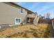 Backyard featuring a covered deck, stairs to yard, and lawn at 9235 Quintero St, Commerce City, CO 80022
