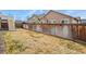 Spacious backyard with a wood fence, offering privacy and room for outdoor activities at 9235 Quintero St, Commerce City, CO 80022