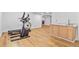 Finished basement with fitness equipment and a wet bar at 9235 Quintero St, Commerce City, CO 80022