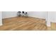 Finished basement showcasing wood-look flooring and ample space for recreation or storage at 9235 Quintero St, Commerce City, CO 80022