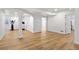 Spacious finished basement with an open floor plan, wood-look flooring, and workout equipment at 9235 Quintero St, Commerce City, CO 80022