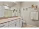 Bathroom featuring a single sink with a white vanity and beach themed decorations at 9235 Quintero St, Commerce City, CO 80022