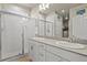 Bathroom features dual sinks, framed mirrors, and a glass shower enclosure at 9235 Quintero St, Commerce City, CO 80022