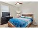 Cozy bedroom with a wooden bed frame and a TV on a dresser at 9235 Quintero St, Commerce City, CO 80022