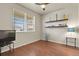 Cozy bedroom is equipped with hardwood floors, a ceiling fan, and a window with blinds at 9235 Quintero St, Commerce City, CO 80022