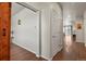 Open hallway features beautiful hardwood floors and neutral walls; doorway leading to living space at 9235 Quintero St, Commerce City, CO 80022