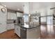 Open kitchen and dining area with an island, granite countertops, and stainless steel appliances at 9235 Quintero St, Commerce City, CO 80022
