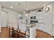 Bright kitchen features an island with seating, granite countertops, stainless steel appliances, and white cabinets at 9235 Quintero St, Commerce City, CO 80022