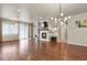 Spacious living room boasts a fireplace with tile surround, hardwood floors, and natural light at 9235 Quintero St, Commerce City, CO 80022