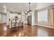 Open layout featuring a bright kitchen with stainless steel appliances and hardwood floors at 9235 Quintero St, Commerce City, CO 80022