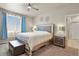 A beautifully decorated bedroom with a large bed, ceiling fan, and natural light at 9235 Quintero St, Commerce City, CO 80022