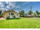 Expansive backyard with lush lawn and charming yellow home at 3100 S Corona St, Englewood, CO 80113