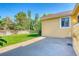 A well-manicured backyard with a concrete patio, a healthy lawn, a wooden fence, and mature trees at 3100 S Corona St, Englewood, CO 80113