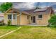 Exterior backyard with a yellow siding and solar panels and a grass lawn at 3100 S Corona St, Englewood, CO 80113