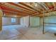 Unfinished basement with exposed wood beams, cement walls, and single window at 3100 S Corona St, Englewood, CO 80113