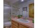 Bathroom featuring a shower with glass doors, large mirror, and wood-toned vanity at 3100 S Corona St, Englewood, CO 80113