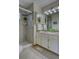 The main bathroom features a tiled shower, double sinks, and designer lighting at 3100 S Corona St, Englewood, CO 80113