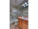 Cozy bathroom with a shower-tub, oak vanity, and a large mirror at 3100 S Corona St, Englewood, CO 80113