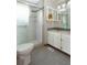 Modern bathroom with a glass-enclosed shower, dual sinks, and eye-catching tile at 3100 S Corona St, Englewood, CO 80113