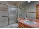 Bathroom with a shower-tub combo, oak vanity and an expansive mirror at 3100 S Corona St, Englewood, CO 80113
