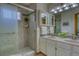 The main bathroom features a tiled shower, double sinks, and designer lighting at 3100 S Corona St, Englewood, CO 80113