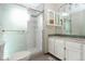 Bathroom featuring a glass enclosed shower, dual sinks and stylish tile accents at 3100 S Corona St, Englewood, CO 80113