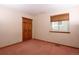Cozy bedroom featuring a window with blinds and a closet with wood doors at 3100 S Corona St, Englewood, CO 80113