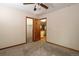 Bedroom features carpet, a ceiling fan, and a doorway to another room and closet at 3100 S Corona St, Englewood, CO 80113