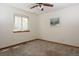 This bedroom has neutral carpet and paint with a window for natural light at 3100 S Corona St, Englewood, CO 80113