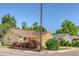 Charming yellow home with lush landscaping and a well-maintained yard on a sunny corner lot at 3100 S Corona St, Englewood, CO 80113