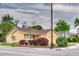 Charming yellow house featuring a well-maintained lawn and landscaping with mature bushes at 3100 S Corona St, Englewood, CO 80113