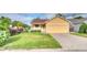 Charming yellow home with a well-maintained front yard and a convenient attached garage at 3100 S Corona St, Englewood, CO 80113