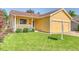Charming single-story home with a well-kept front lawn, a cozy porch, and an attached two car garage at 3100 S Corona St, Englewood, CO 80113