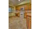 This kitchen offers tile flooring, wood cabinets, and essential appliances for cooking at 3100 S Corona St, Englewood, CO 80113
