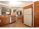 Open kitchen area with wood cabinets, stainless steel appliances, and a breakfast bar at 3100 S Corona St, Englewood, CO 80113
