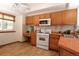 Cozy kitchen with light wood cabinets, tile countertops, and a window offering natural light at 3100 S Corona St, Englewood, CO 80113