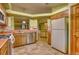 Functional kitchen with wood cabinetry, stainless steel appliances, and tile flooring at 3100 S Corona St, Englewood, CO 80113