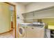 Laundry room featuring washer, dryer, shelving, and view into other rooms at 3100 S Corona St, Englewood, CO 80113