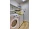 Bright laundry room with washer, dryer, and convenient shelving at 3100 S Corona St, Englewood, CO 80113