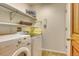 Convenient laundry room with washer, dryer, and storage shelves at 3100 S Corona St, Englewood, CO 80113