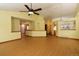 Open living room with wood floors, ceiling fan, and easy access to other areas of the home at 3100 S Corona St, Englewood, CO 80113