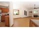 Bright living space showcasing an open floor plan with a view of the adjacent kitchen and fireplace at 3100 S Corona St, Englewood, CO 80113