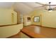 Living room featuring wood floors, a ceiling fan, and an open layout that seamlessly connects to the kitchen at 3100 S Corona St, Englewood, CO 80113