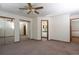 Comfortable main bedroom with ensuite bath offers neutral walls and mirrored closet doors at 3100 S Corona St, Englewood, CO 80113
