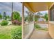 View from the covered porch showcasing neighborhood greenery, landscaping, and a street view at 3100 S Corona St, Englewood, CO 80113