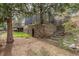 Charming backyard with stone steps, a sturdy retaining wall, and iron fencing at 1264 Beaver Brook Canyon Rd, Evergreen, CO 80439