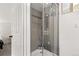 Modern bathroom with a glass shower, gray tiling, and natural light from the window at 1264 Beaver Brook Canyon Rd, Evergreen, CO 80439
