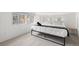Light filled bedroom with a minimalist design, natural light and a metal bed frame at 1264 Beaver Brook Canyon Rd, Evergreen, CO 80439