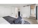 Spacious bedroom boasts sliding door to a bathroom, exposed wood ceiling, and gray accents at 1264 Beaver Brook Canyon Rd, Evergreen, CO 80439